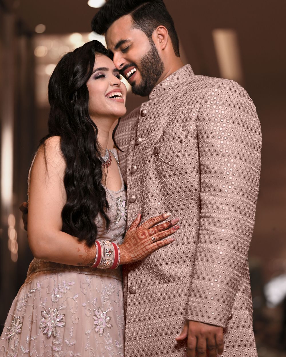 A couple laughing together at their wedding